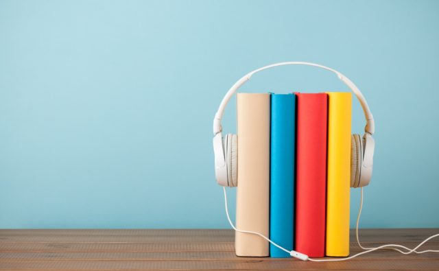 Stack of books with headphones