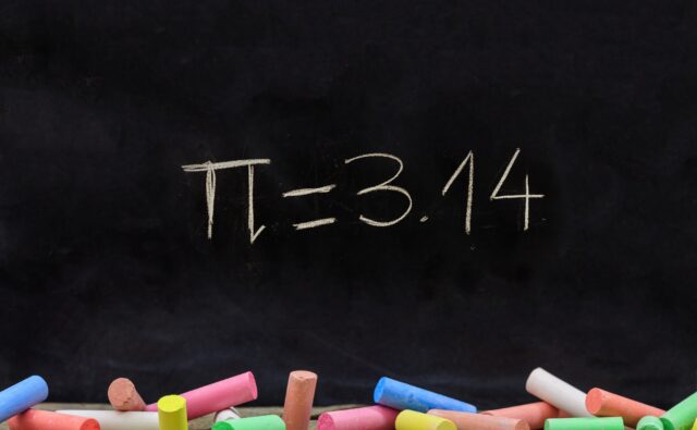 Pi number, mathematical constant chalk drawing on a school black board
